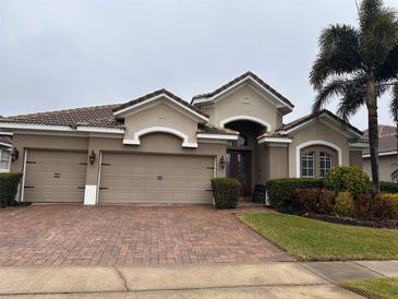 Two-story house with three car garage and landscaped yard at 11626 Vicolo Loop, Windermere, FL 34786