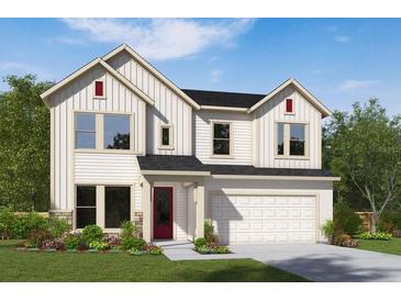 Two-story farmhouse-style home with white siding, red door, and a two-car garage at 16959 Cedar Valley Cir, Clermont, FL 34711