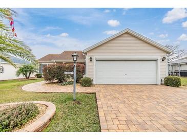 One-story home with attached garage and landscaped yard at 3096 Lansing Way, The Villages, FL 32162