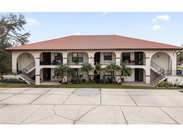 Front view of a two-story building with Spanish-style architecture, featuring terracotta roofs and balconies at 3004 Granada Ct # 3004, Lake Wales, FL 33898