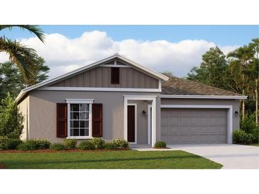 Attractive one-story house with a two-car garage and landscaped lawn at 251 Puma Loop, Groveland, FL 34736