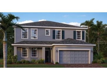 Two-story house with gray siding, attached garage, and landscaping at 274 Puma Loop, Groveland, FL 34736