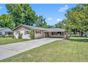 Ranch-style home with carport and spacious lawn at 5018 Se 106Th Pl, Belleview, FL 34420