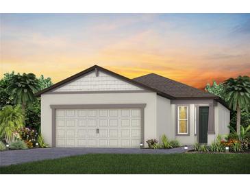 One-story house with two-car garage, light-colored walls, and a dark brown roof at 5879 Sw 87Th Ave, Ocala, FL 34481