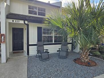 Updated townhouse with welcoming front yard, featuring two chairs and palm tree at 820 W 25Th St, Sanford, FL 32771