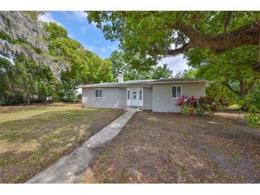 Charming one-story home featuring a well-maintained front yard and a quaint entrance walkway at 1412 E Main St, Lakeland, FL 33801