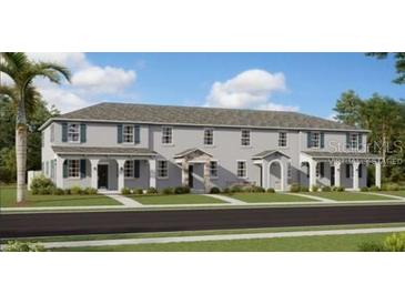 Three-unit townhome building, featuring front porches and a traditional design at 2591 Candied Apple Aly, Kissimmee, FL 34744