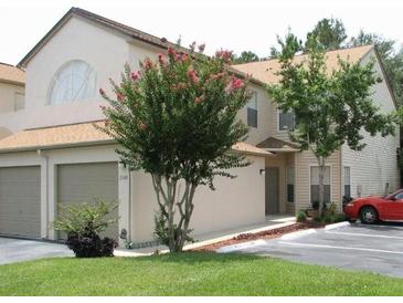 Two-story townhome with attached garage and landscaped yard at 2948 W Cottage Grove Ct # Ge, Orlando, FL 32822