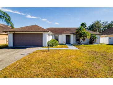Single-story home with attached garage and well-maintained lawn at 3088 Sire Trl, Lakeland, FL 33811