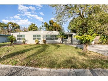 Ranch style home with a large yard and mature trees at 5883 Dogwood Dr, Orlando, FL 32807