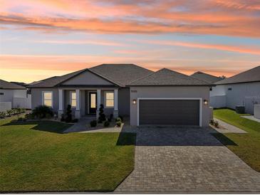 One-story home with a two-car garage and attractive landscaping at 7021 Bentridge Dr, Lakeland, FL 33813