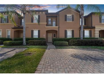 Two-story townhome with brick paver walkway at 225 Cambria Ave, Davenport, FL 33897