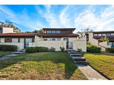 Attractive single-story home with red tile roof and landscaped lawn at 5 Loma Linda # 5, Lakeland, FL 33813