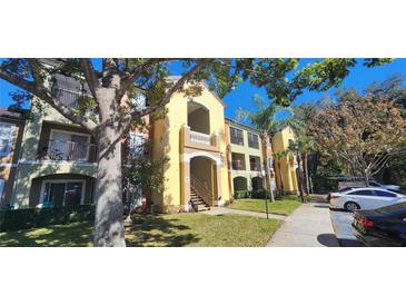 Condo building with multiple units, balconies, and ample parking at 713 Crest Pines Dr # 236, Orlando, FL 32828