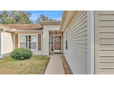 Inviting home exterior with a wreath on the front door and neutral siding at 4064 River Crest Cir, Leesburg, FL 34748