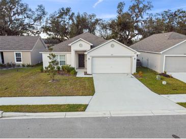 Single-story house with attached garage and front yard at 1976 Thompson Preserve Blvd, Bartow, FL 33830