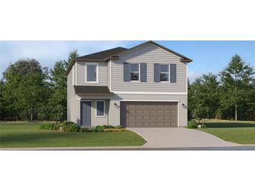 Two-story home with gray siding, brown garage door, and landscaping at 1294 Deepwater Cir, Eagle Lake, FL 33839