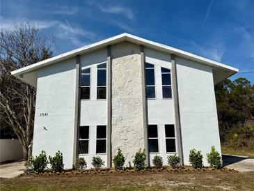 White two-story building with stone accents and landscaping at 2541 E Lake Dr, Deland, FL 32724