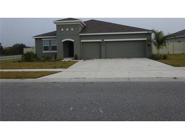 Charming single-story home with a two-car garage and well-maintained landscaping at 400 Watusi Way, St Cloud, FL 34772