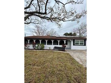 Updated ranch home with a large front yard and carport at 1703 Mona Ave, Ocoee, FL 34761