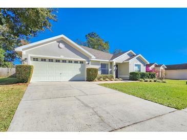 Charming single Gathering home featuring a two car garage and well-maintained landscaping at 6830 Krenson Oaks Cir, Lakeland, FL 33810