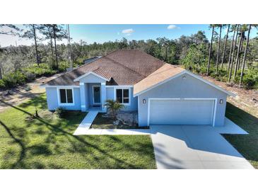 Charming single-Gathering home with a well-manicured lawn and a two-car garage at 4101 Poinciana Dr, Indian Lake Estates, FL 33855