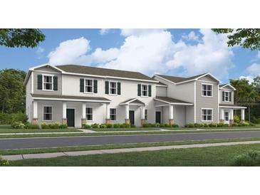 Beautiful new construction townhome with modern architectural details and lush landscaping at 5892 Meditation Dr, Clermont, FL 34714