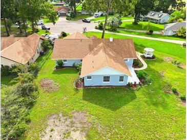 Charming single story home on a large lot featuring a manicured lawn and a quaint gazebo at 10672 Sw 75Th Ter, Ocala, FL 34476
