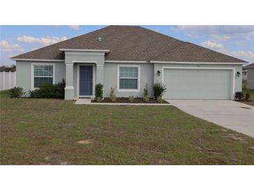 Charming single Gathering home featuring a well manicured lawn, and a two car garage at 512 Central Ridge Ln, Frostproof, FL 33843