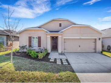 Charming single-story home featuring a well-maintained lawn and inviting front entrance and attached two car garage at 3214 Bayou Bay Dr, Lakeland, FL 33811