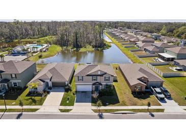 An aerial view of a community with pond views and well-maintained lawns in a desirable neighborhood at 4323 Trotters Way, Lakeland, FL 33801