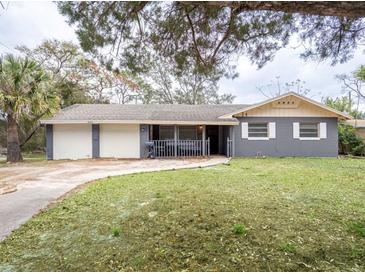 Charming single Gathering home with a two car garage and a front porch at 2001 Cricket Dr, Orlando, FL 32808