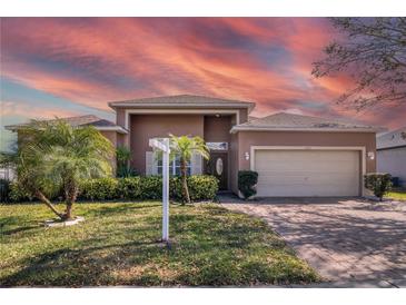 Inviting exterior showcasing a well-manicured lawn and lush landscaping at 3890 Wood Thrush Dr, Kissimmee, FL 34744