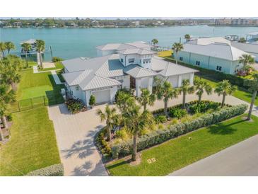 Stunning waterfront home with lush landscaping, metal roof, and private dock at 472 Desoto Dr, New Smyrna Beach, FL 32169