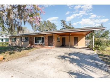 Charming single-story home with mature trees, covered parking, and a traditional brick facade at 800 22Nd Nw St, Winter Haven, FL 33881