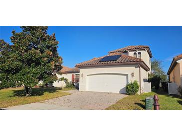 Charming single Gathering home with a two car garage, tile roof and solar panels on the roof at 315 Villa Sorrento Cir, Haines City, FL 33844