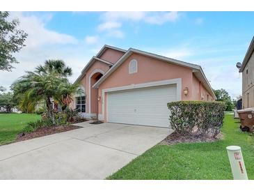 Charming single-Gathering home with a two-car garage and a well-manicured front lawn at 1310 Seasons Blvd, Kissimmee, FL 34746