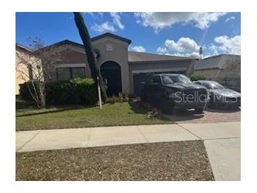Charming single-story home featuring a well-maintained lawn and a welcoming front entrance at 9362 Oglethorpe Dr, Groveland, FL 34736