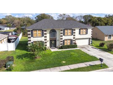 Charming two-story home with a well-manicured front yard and attractive exterior at 114 Shaddock Dr, Auburndale, FL 33823