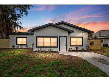 Charming single-story home featuring fresh exterior paint and a well-manicured front yard with new landscaping at 2015 Poe St, Lakeland, FL 33801