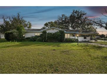 Charming single-story home featuring a well-manicured front yard and a convenient carport at 2640 Oak Dr, Bartow, FL 33830