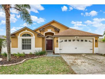 Charming single-Gathering home featuring a well-manicured lawn and a two-car garage, perfect for suburban living at 390 Lisa Karen Cir, Apopka, FL 32712