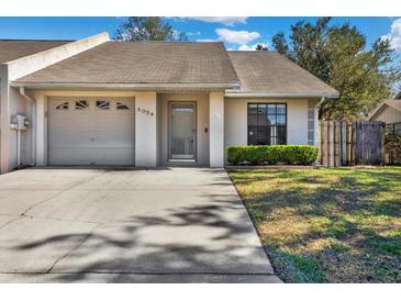 Charming single-story home with attached garage, well-maintained lawn, and inviting front entrance at 5054 Fairfield Dr, Lakeland, FL 33811