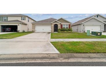 Charming single-story home with a well-maintained lawn and a two-car garage at 2723 Elmbrooke Way, Edgewater, FL 32141