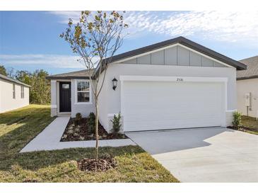 Charming single-story home with a two-car garage, manicured lawn and simple landscaping at 2530 Linda Knoll Ln, Bartow, FL 33830