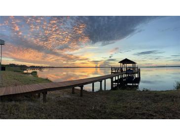 Waterfront property featuring a private dock with a gazebo at sunset at 3254 E Canal Ln, Fort Meade, FL 33841