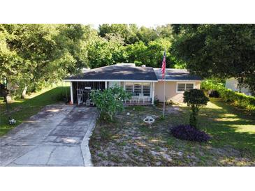 Charming single-story home featuring a quaint front yard and a long driveway at 111 2Nd St # Jpv, Winter Haven, FL 33880