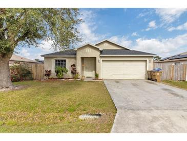 Charming single-Gathering home featuring a well-manicured lawn and attached two-car garage at 114 Briarcliff Dr, Kissimmee, FL 34758