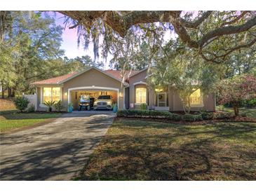 Charming single-story home with a well-manicured front yard and covered parking at 7641 Sw 185Th Cir, Dunnellon, FL 34432