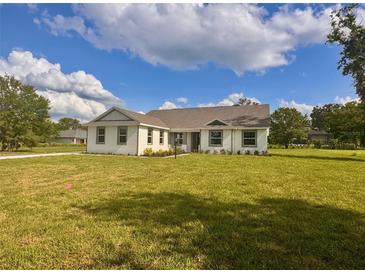 Charming single-story home with a well-maintained lawn and bright exterior at 2569 Rogers Rd, Lakeland, FL 33812